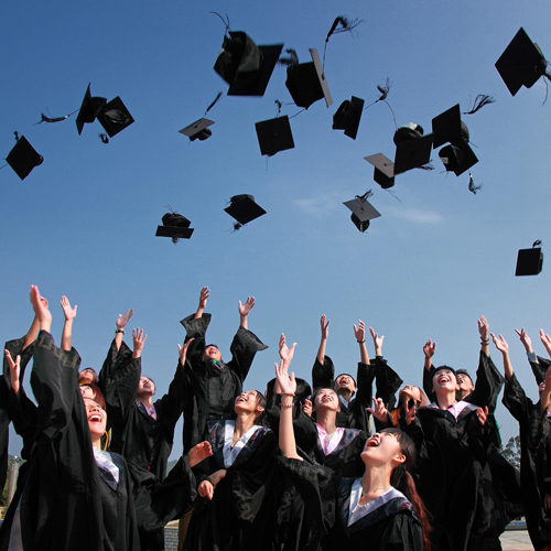 Grads throwing caps into the air