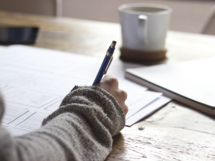 Student taking notes while studying