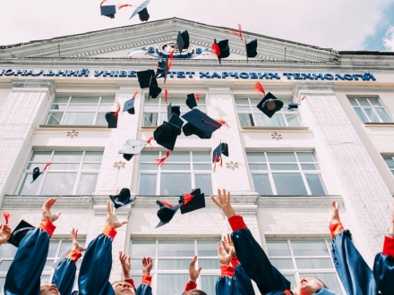 Students throwing caps into the air during graduation