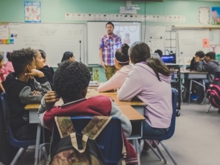 Teacher instructing class full of students